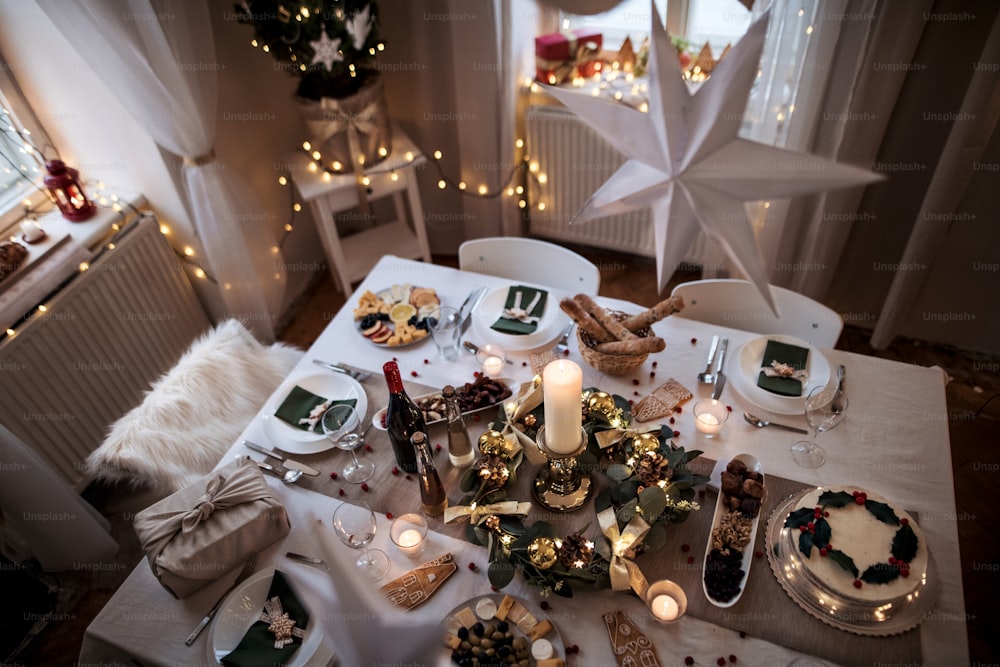 Top view of a table set for dinner meal at Christmas time.