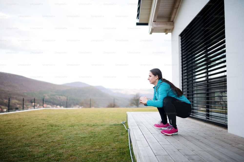 Woman with face masks doing exercise outdoors at home, Corona virus and quarantine concept.