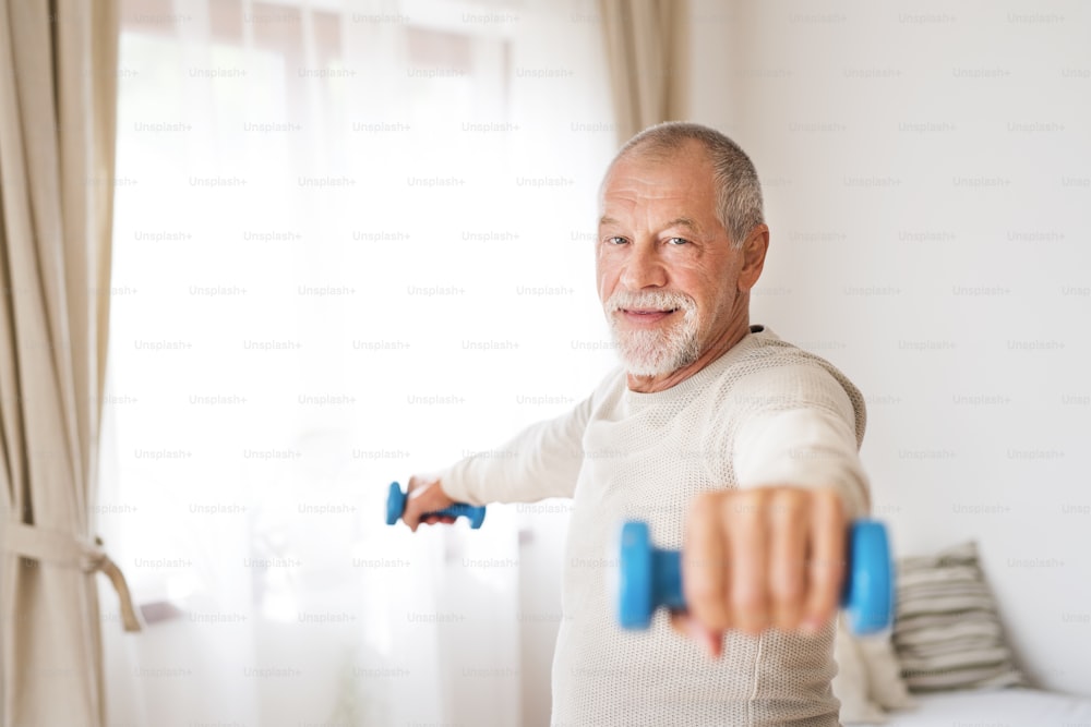 Active senior man doing exercise at home.