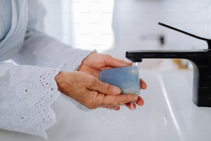 A close-up of woman washing hands with natural lavender soap, ecological sustainable lifestyle.