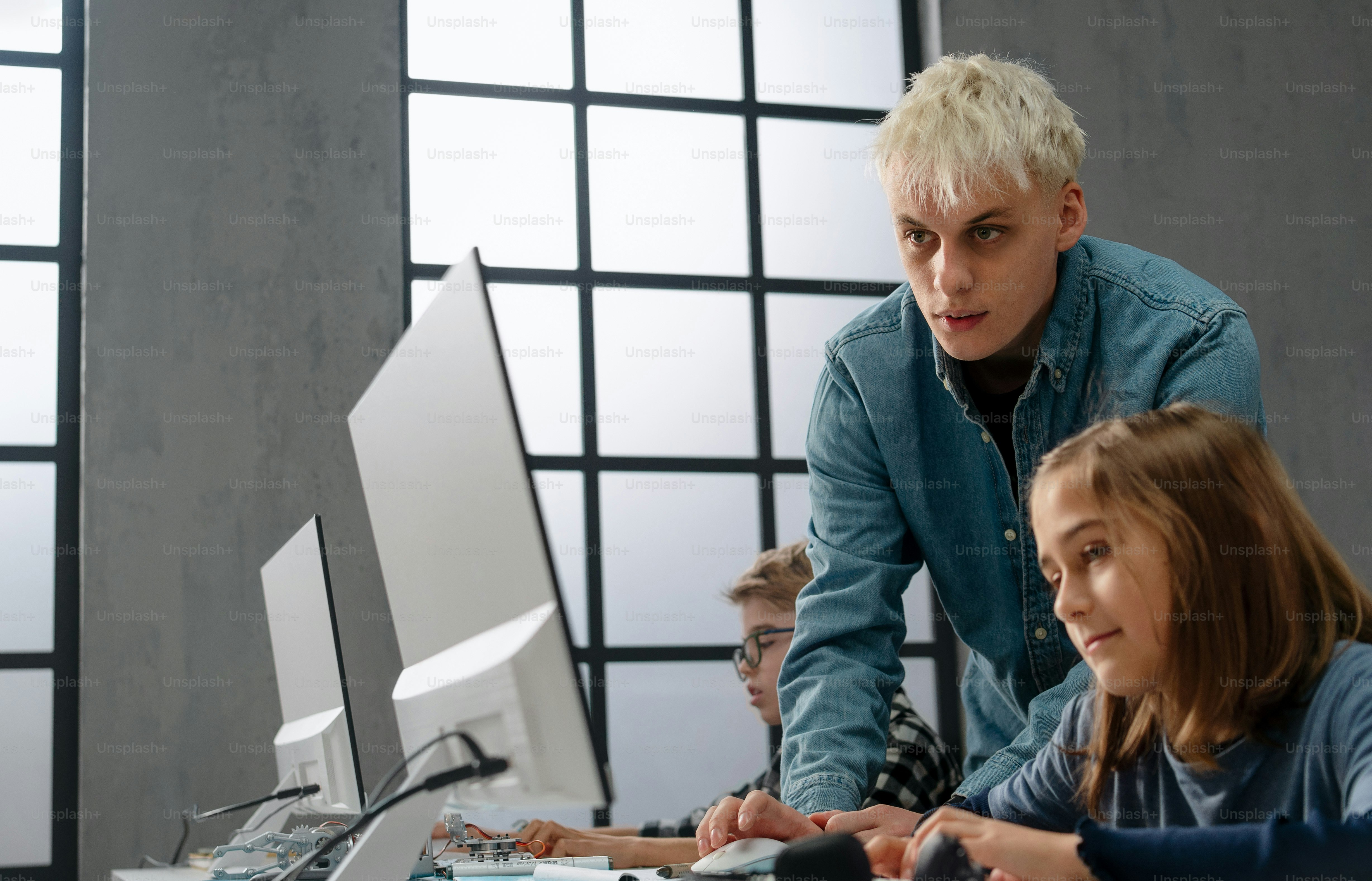 School kids using computer in a classroom at school photo – Student ...