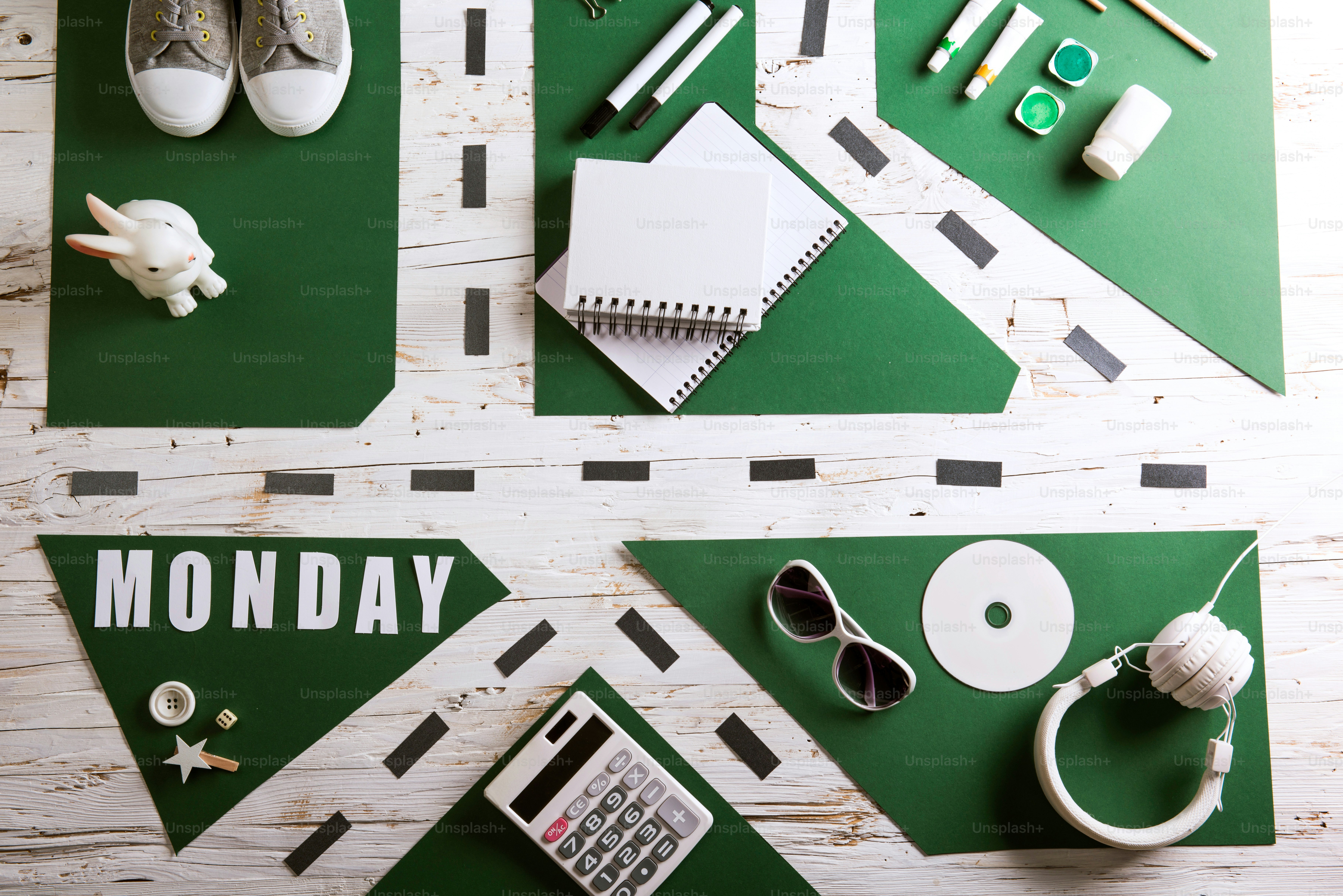 Desk with school supplies. Studio shot on white wooden background.