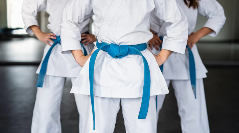 Young martial arts students training in a gym
