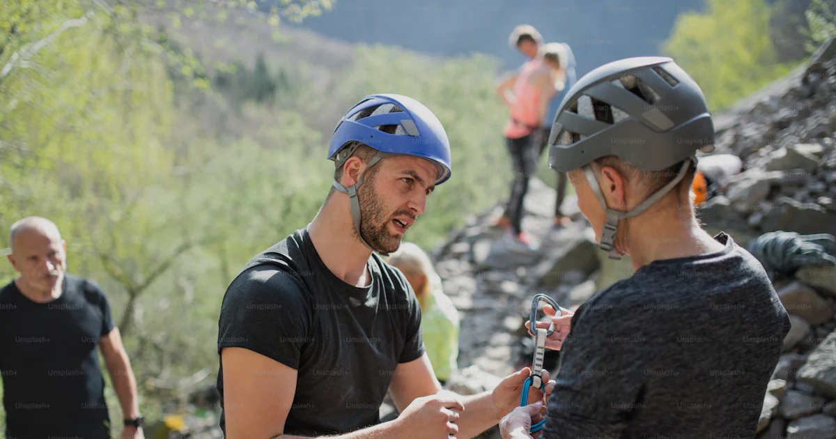 Active Living Rocks A group of seniors with instructor climbing rocks outdoors in nature ...
