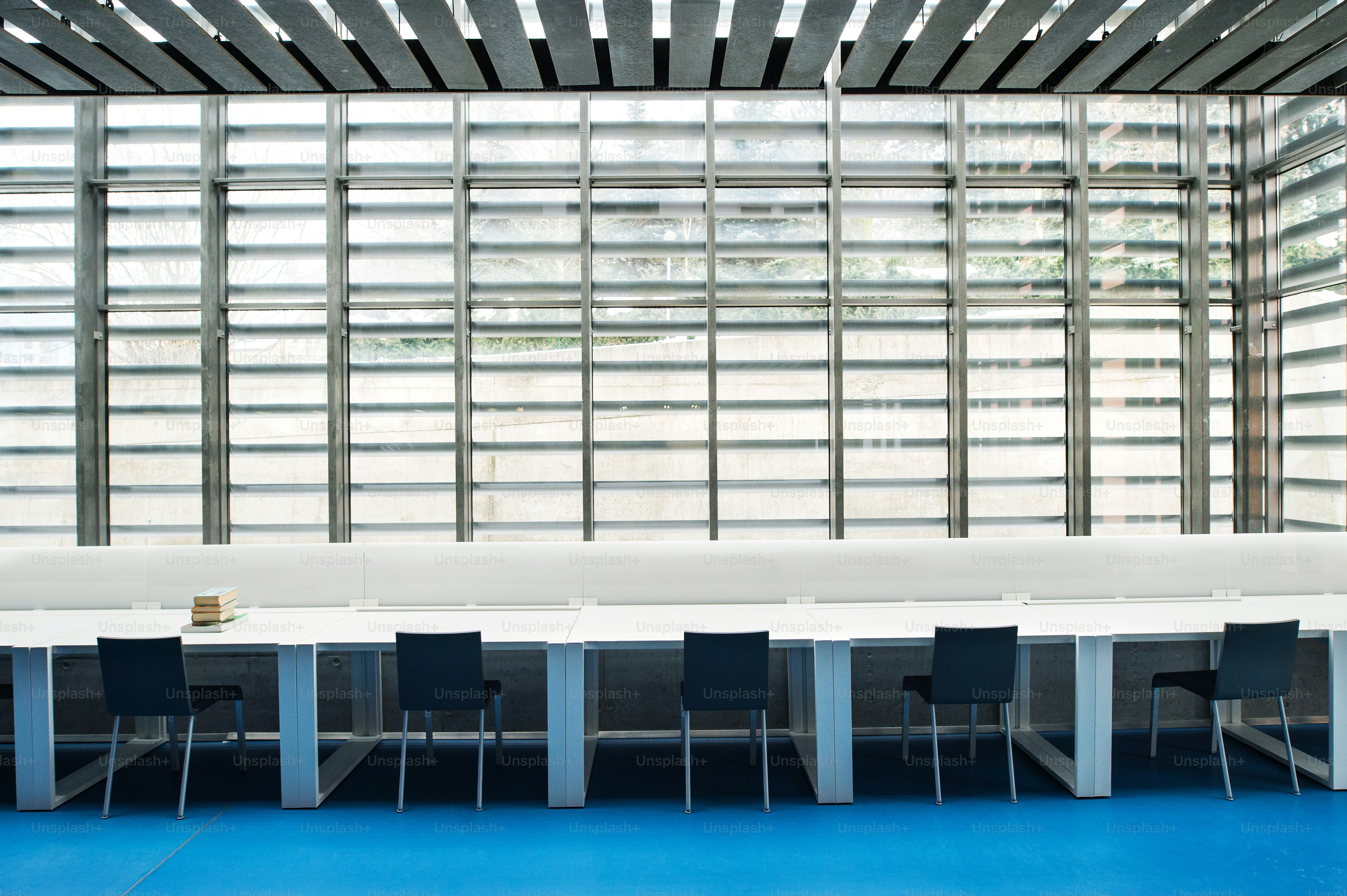 An interior of a modern spacious study room for students in a library ...