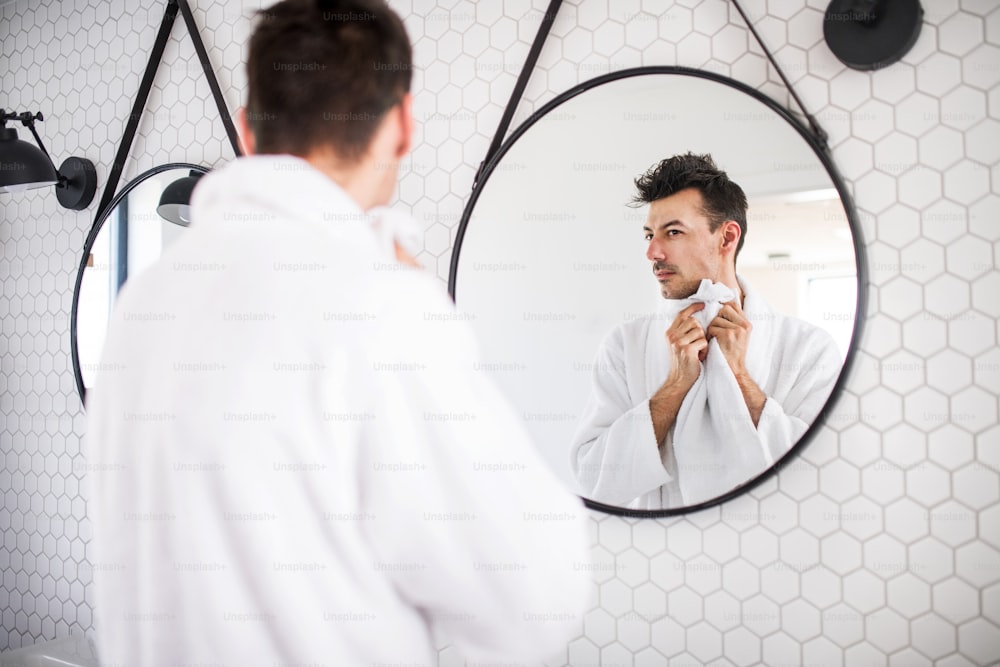 A young man washing in the bathroom in the morning, a daily routine.