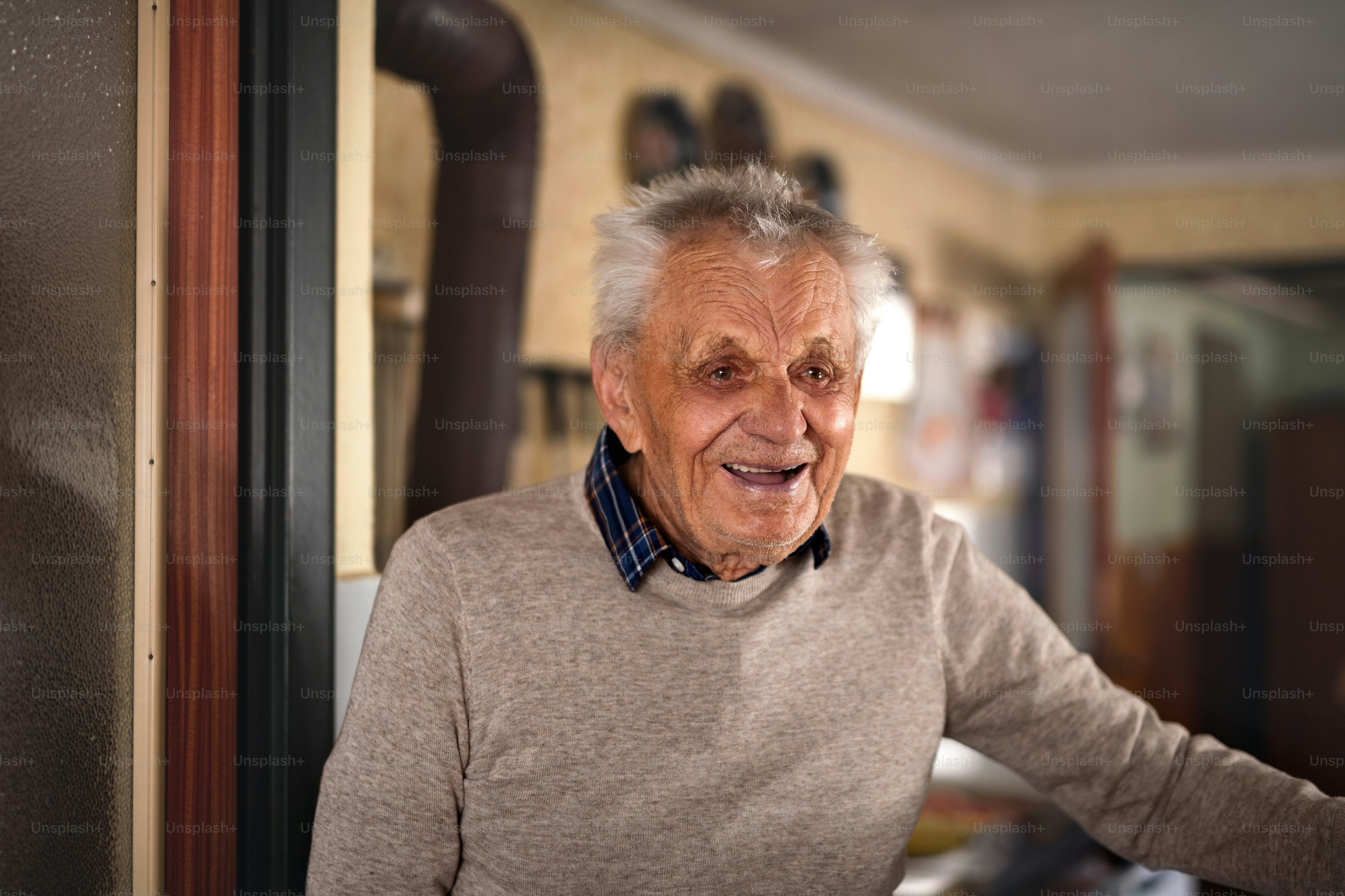 [SUGGESTED IMAGE: Elderly gentleman in a heritage railway volunteer vest examining a detailed model railway layout at an exhibition]