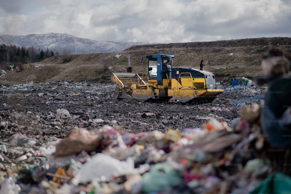 Garbage truck unloading waste on landfill, environmental concept. Copy space.