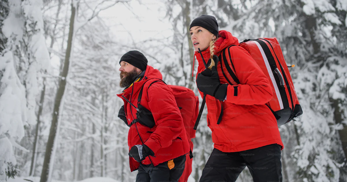 Walking Rescuers Low angle view of paramedics from a mountain rescue service walking ...