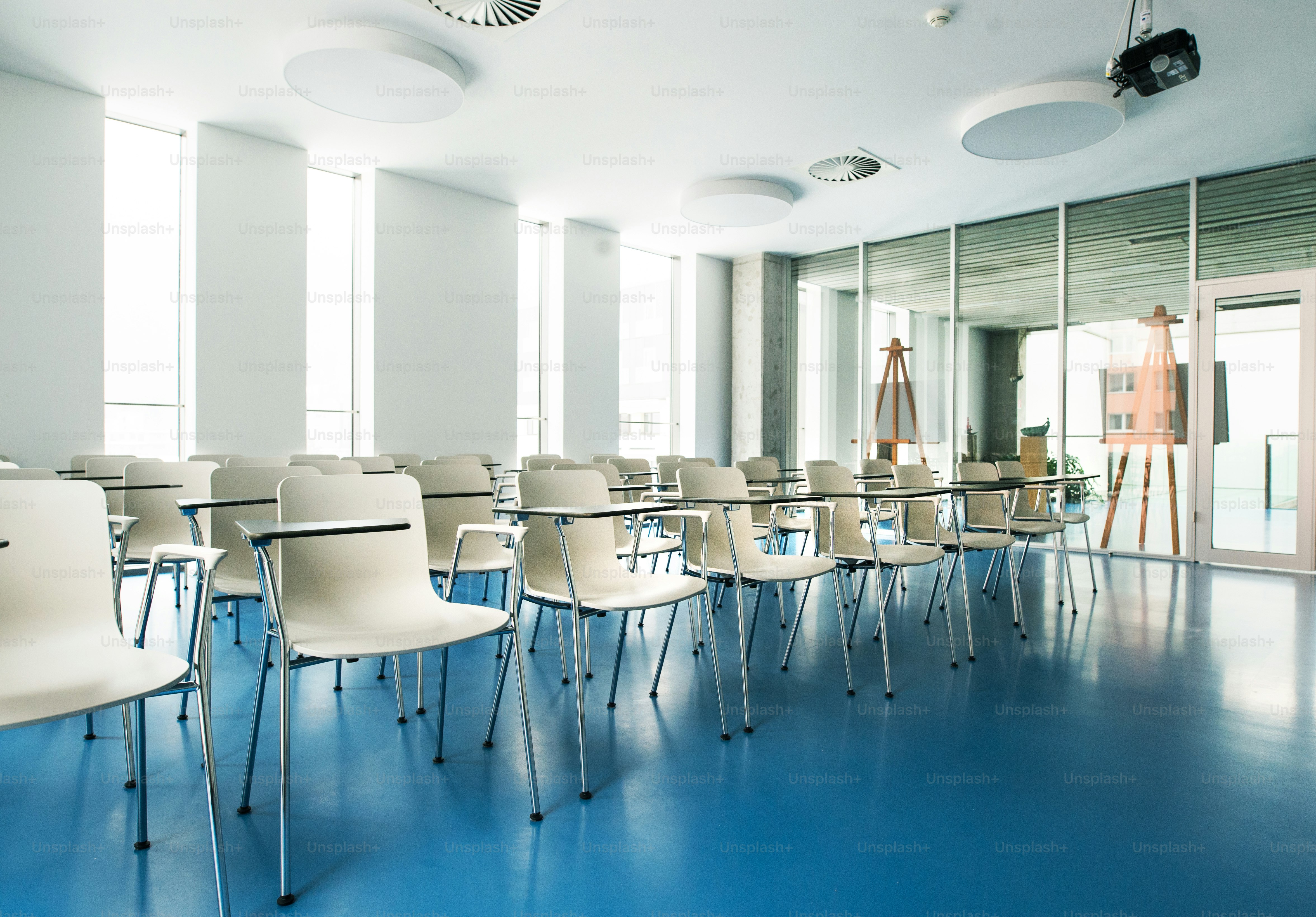 An interior of a modern spacious study room for students in a library ...