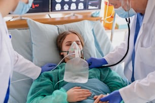 An infected patient in quarantine lying in bed in hospital, coronavirus concept.