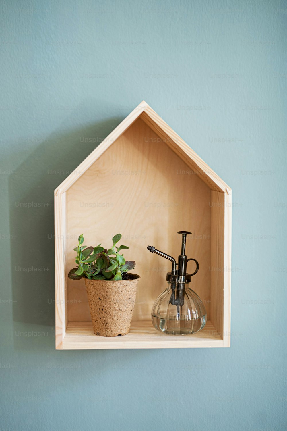 Front view of wooden house shelf with decorations on the wall, natural decor concept.