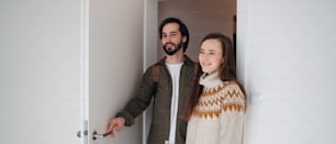 Happy young couple moving in new flat, new home and relocation concept.