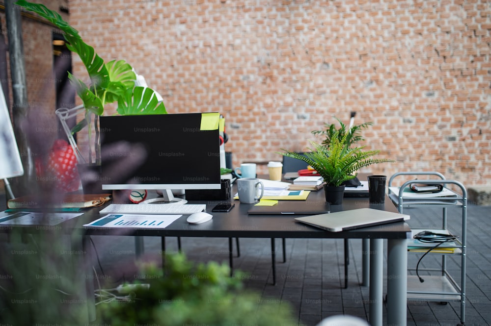 Desks with computers and other office supplies, a coworking concept.