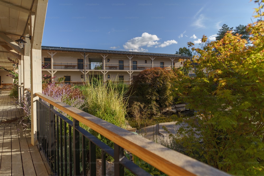 A view from terrace of modern hotel with garden and pond