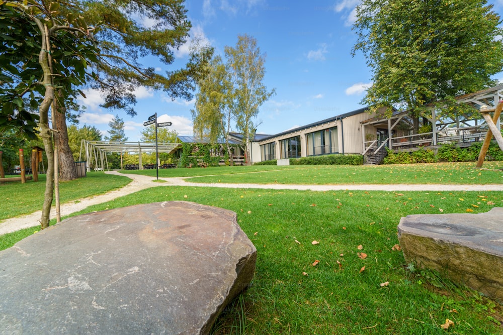 An outdoor hotel area with garden and navigational arrows