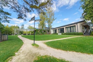 An outdoor hotel area with garden and navigational arrows