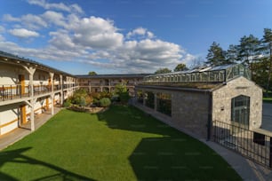 An outdoor hotel area with garden and greenhouse