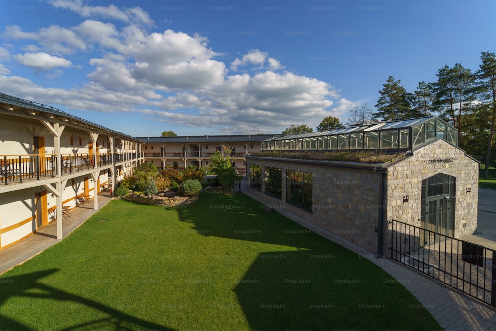 An outdoor hotel area with garden and greenhouse