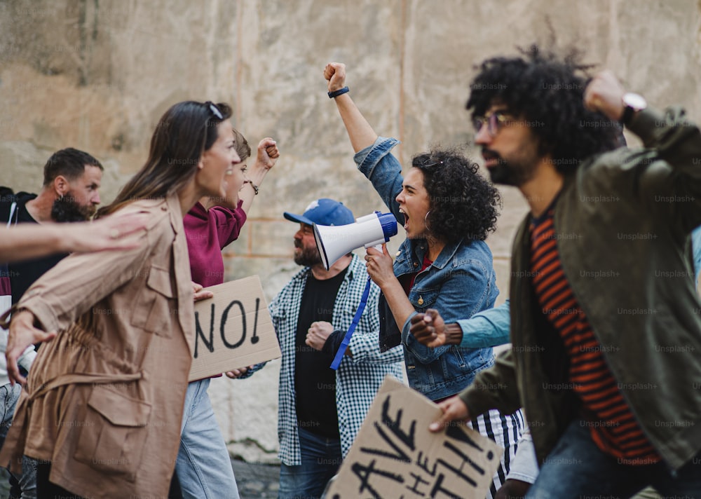 Group of shouting people activists protesting on streets, strike, demonstration and fight concept.