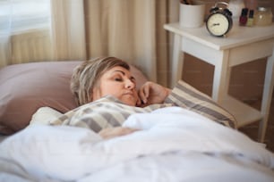 An overweight woman sleeping in bed at home.