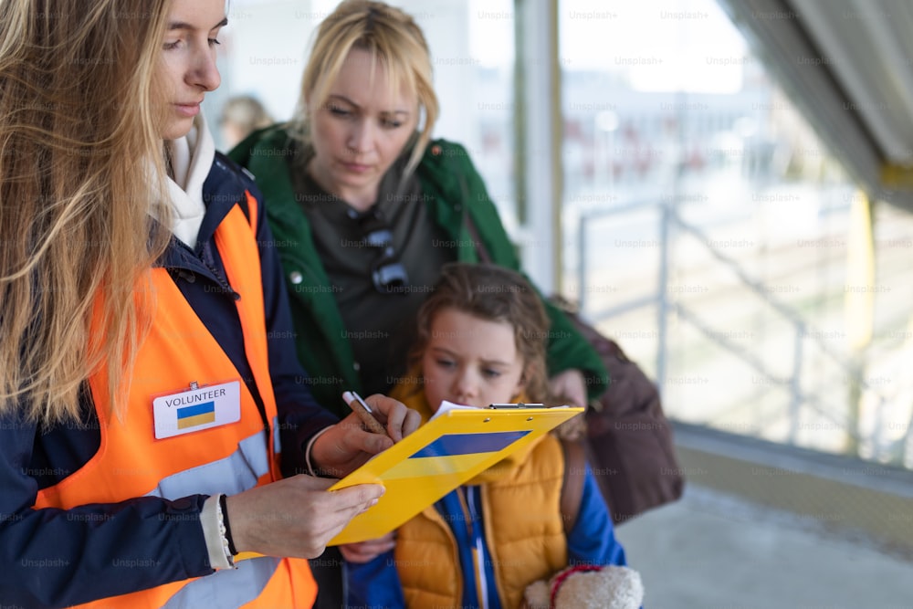 A volunteer registring Ukrainian refugees at train station.