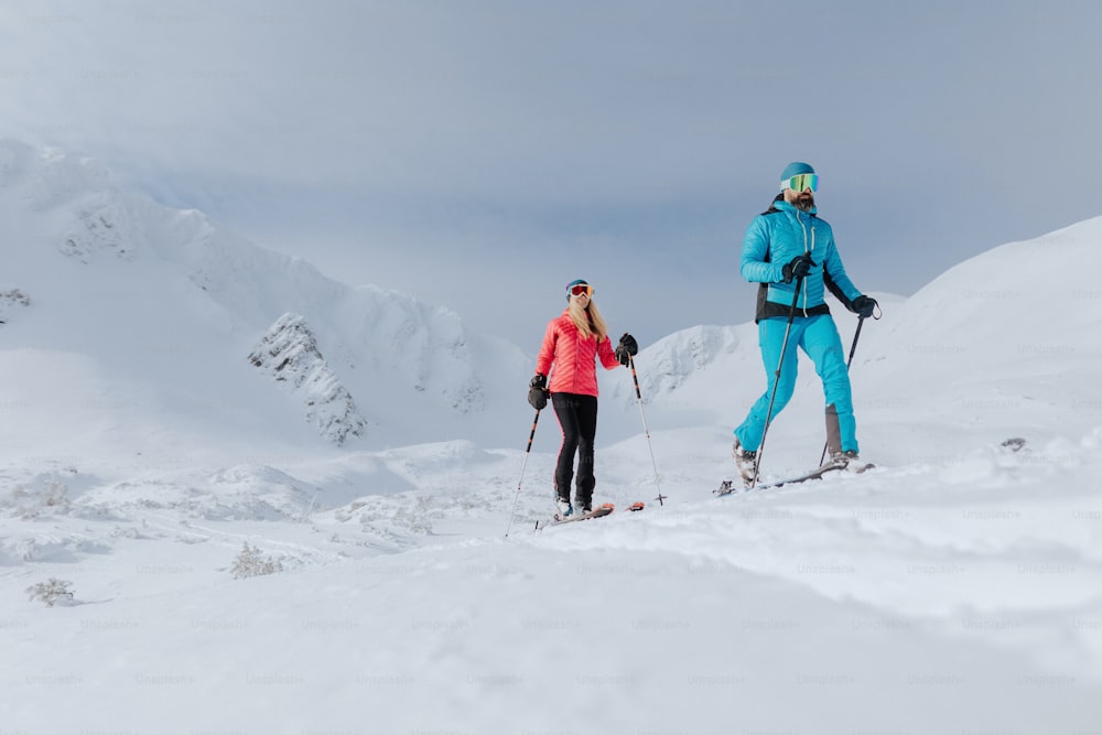 A ski touring couple hiking up a mountain in the Low Tatras in Slovakia.