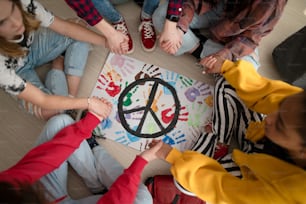 Eine Draufsicht auf Schüler, die in der Schule für den Frieden in der Welt beten.