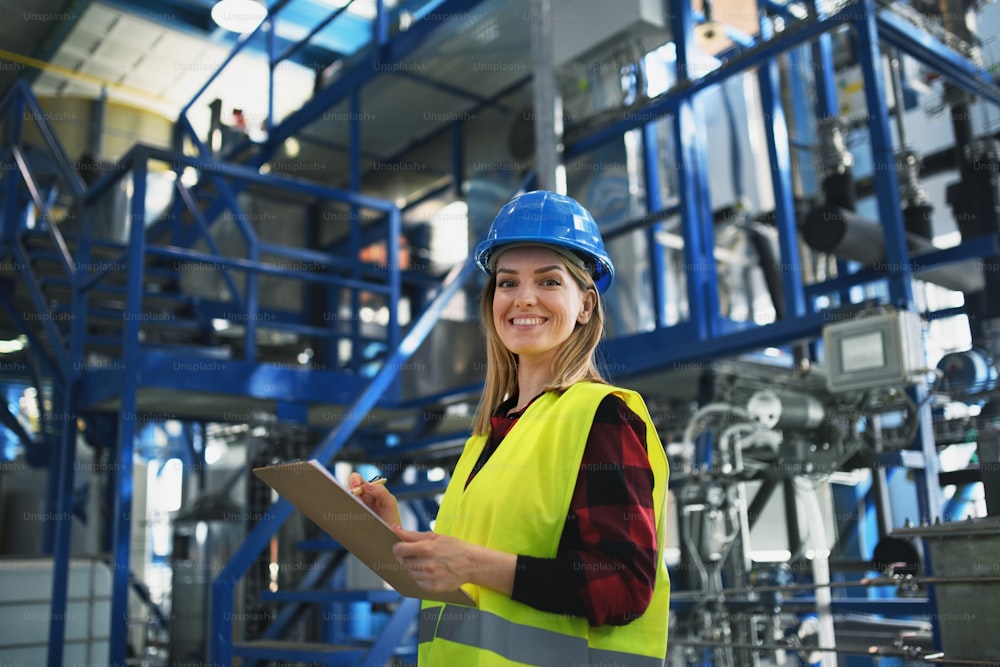 A portrait of female engineer working in industrial factory