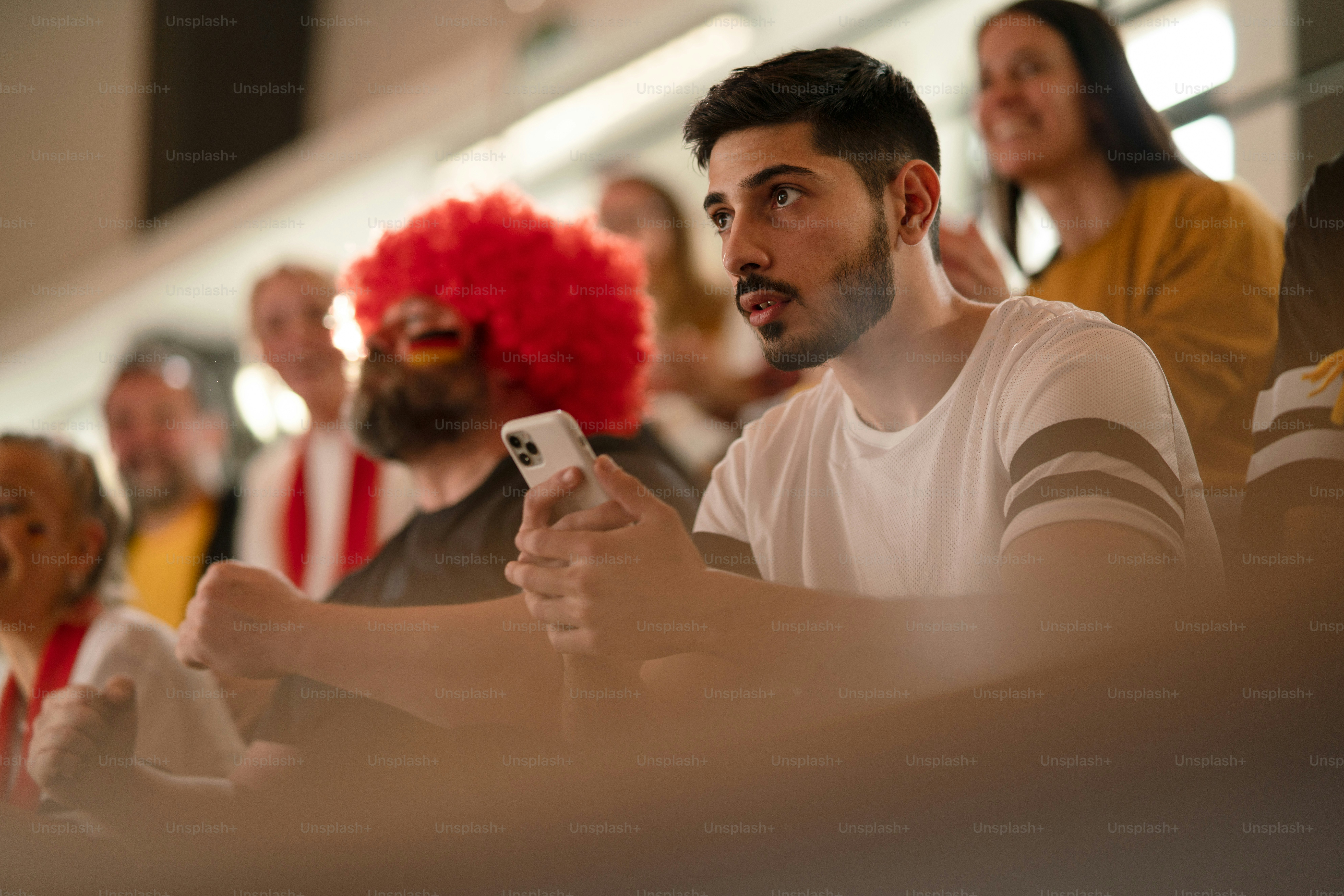 Worried football fans supproting a German national team in live soccer match at stadium