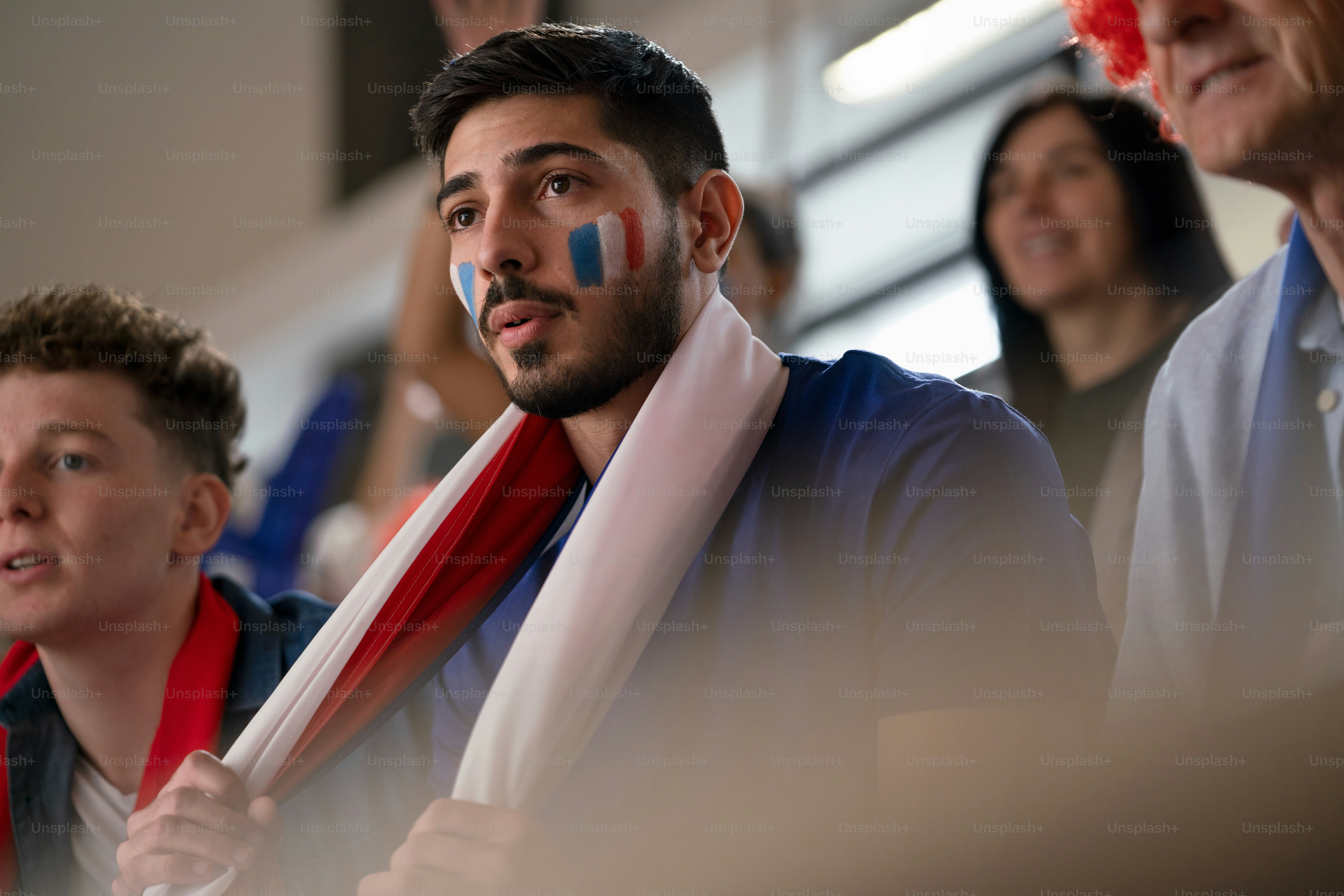 Worried football fans supproting a French national team in live soccer