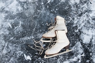 Old womans ice skates lying on the ice. Close up.