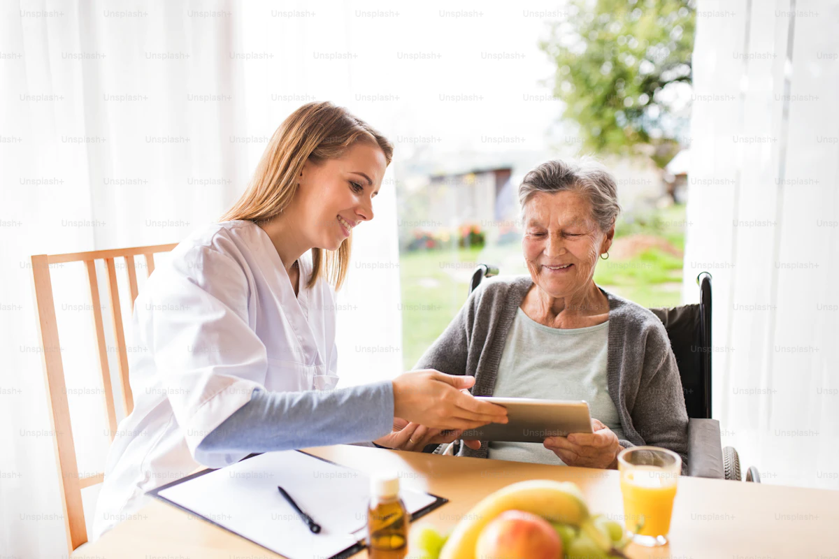 Caregiver talking with an older client during a home visit