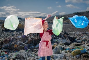 Woman housewife on landfill, consumerism versus plastic pollution concept.