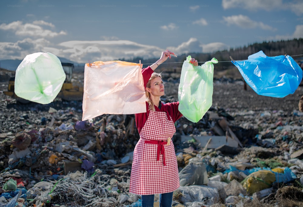 Woman housewife on landfill, consumerism versus plastic pollution concept.