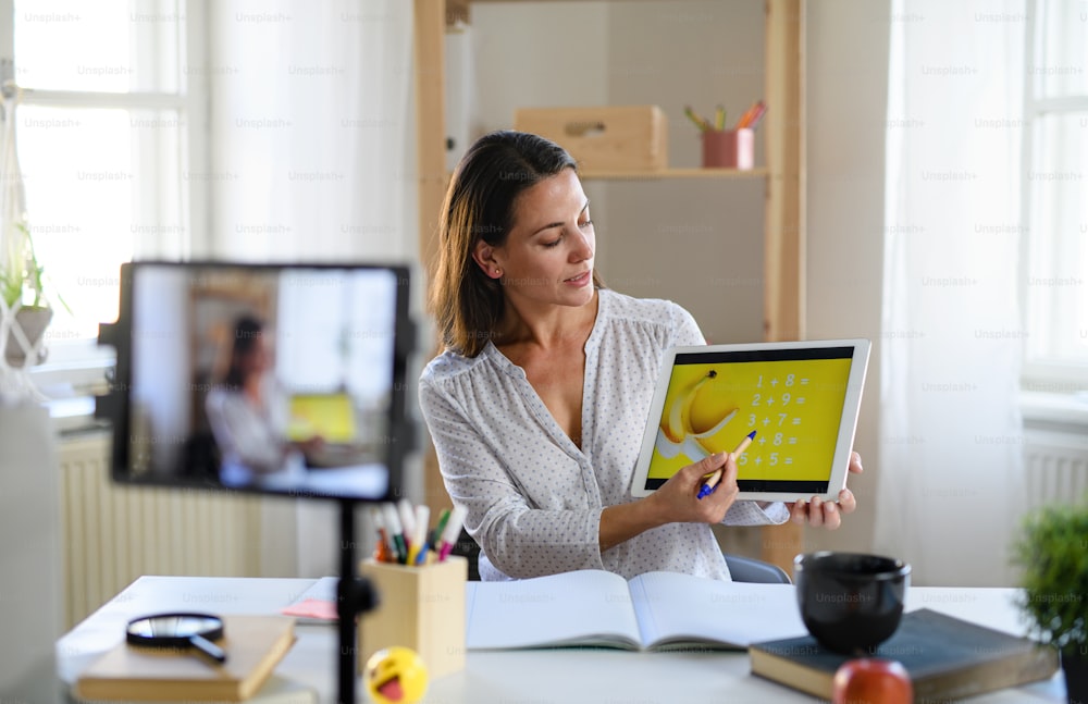 Portrait of woman teacher teaching online, coronavirus and online distance learning concept.