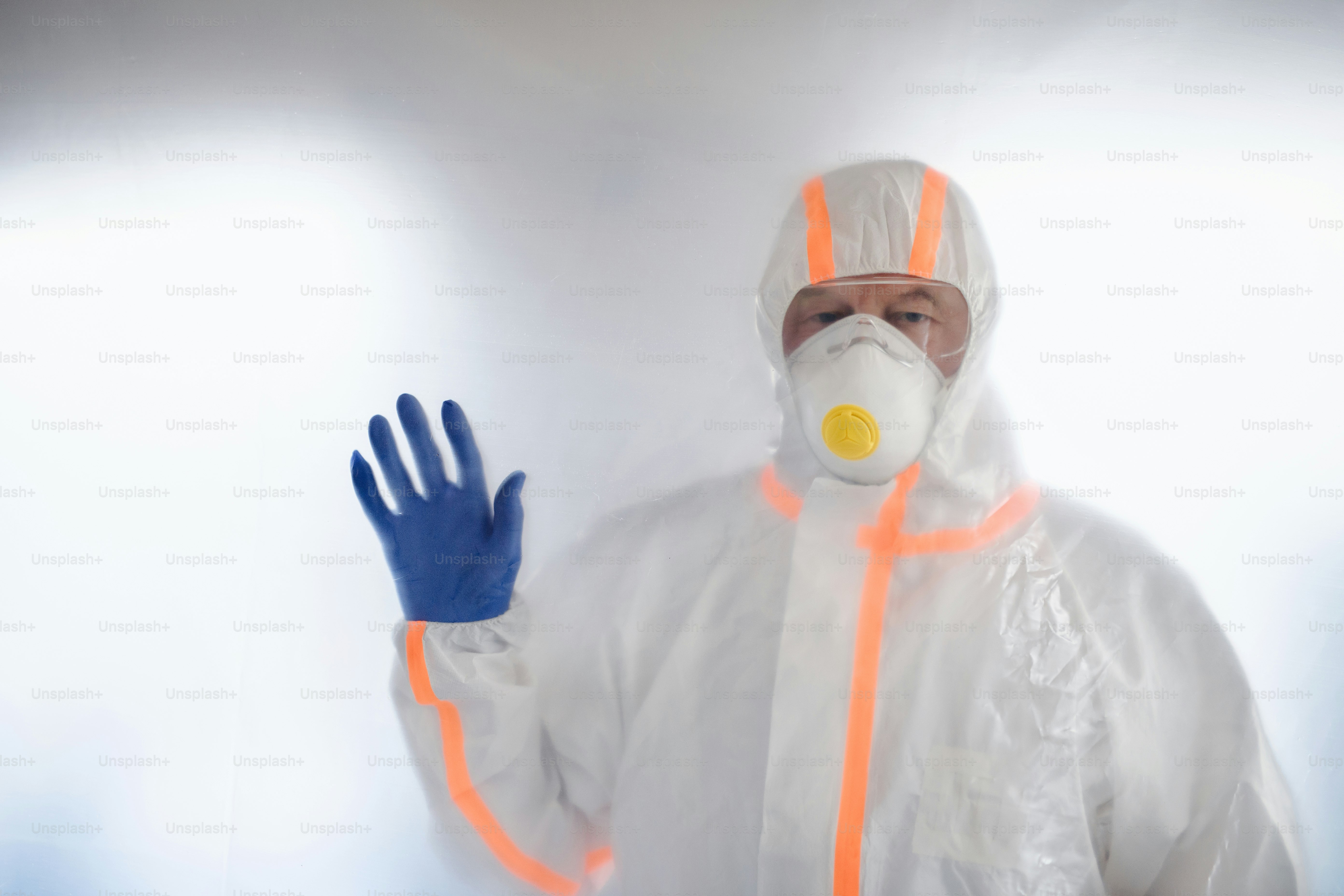 Doctor with protective suit, mask and gloves, coronavirus concept. Copy space