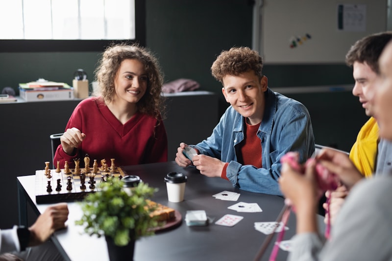 Group of people playing cards and board games in a community center