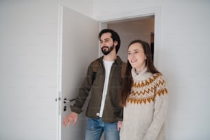 Happy young couple moving in new flat, new home and relocation concept.
