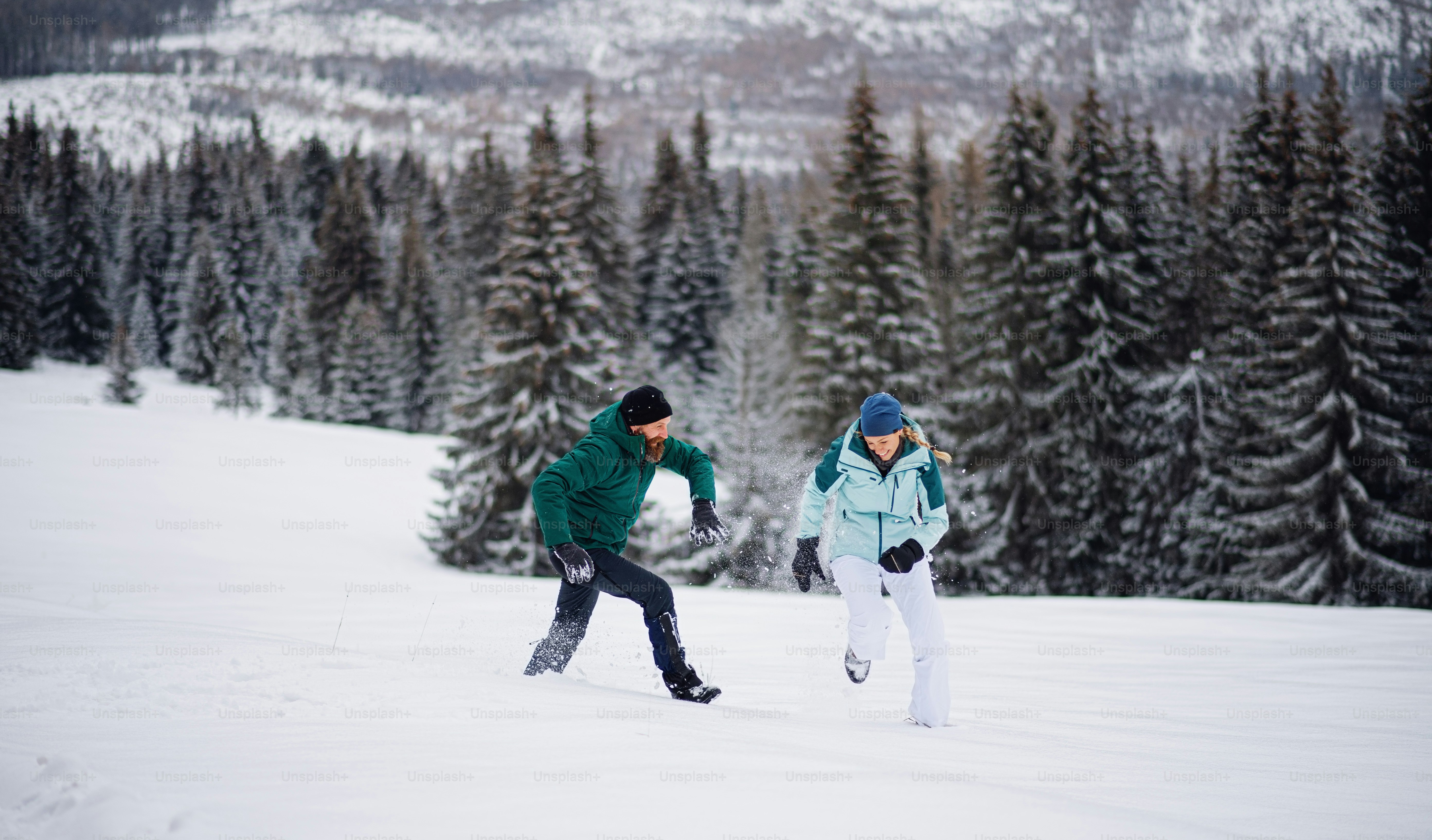 Mature couple having fun outdoors in a winter nature, Tatra mountains Slovakia.