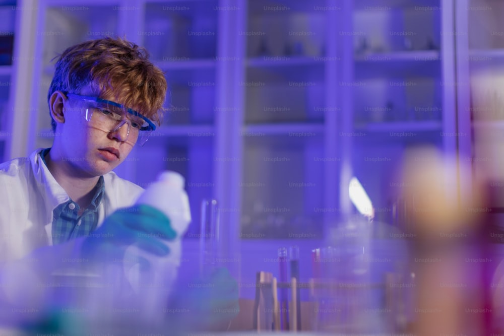 A science student doing chemical experiment in the laboratory at university.