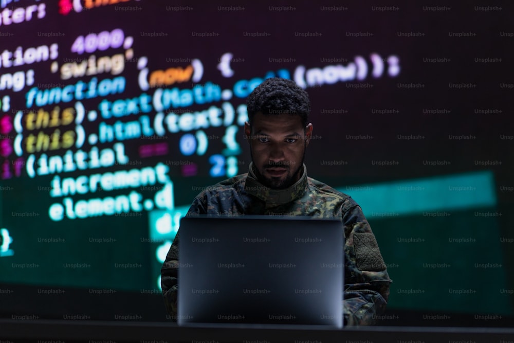 A hacker in military unifrorm on dark web, cyberwar concept.