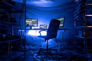An internet hacker workplace in dark office, cyberwar concept.