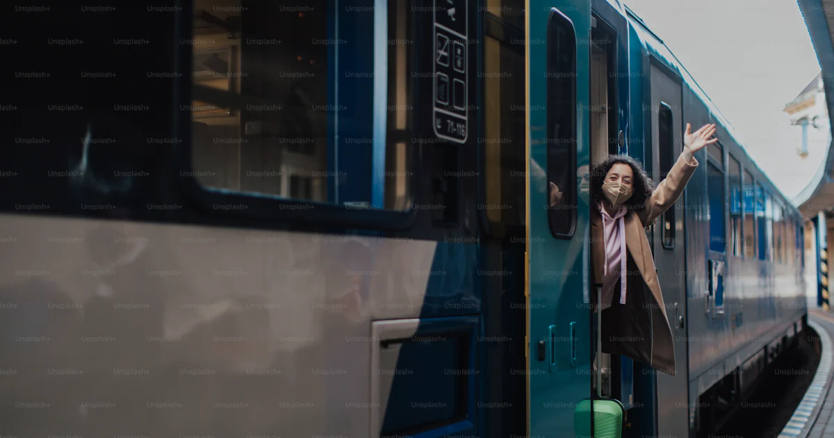 Getting A Train A happy young traveler woman with luggage getting off the train at ...