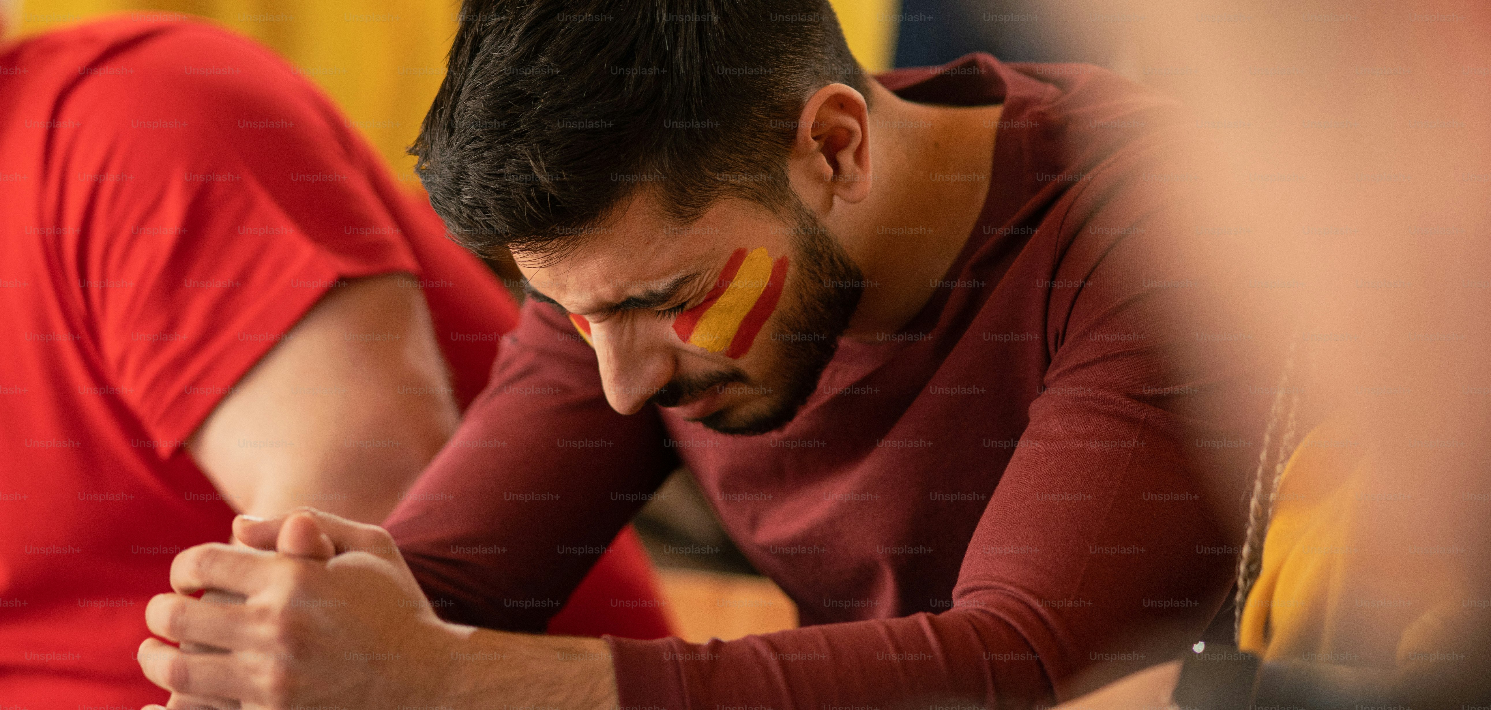 Sad football fan sitting at football stadium a spanish national team in live soccer match