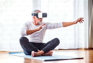 Active senior man with VR goggles doing exercise at home.