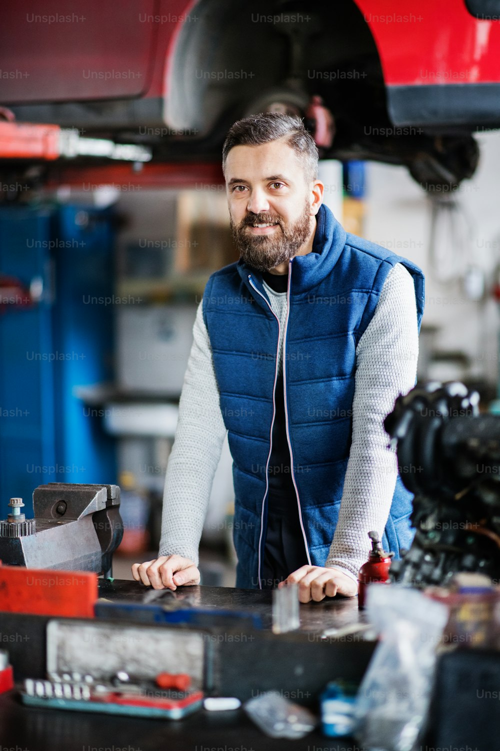 Portrait of a man mechanic in a car garage.