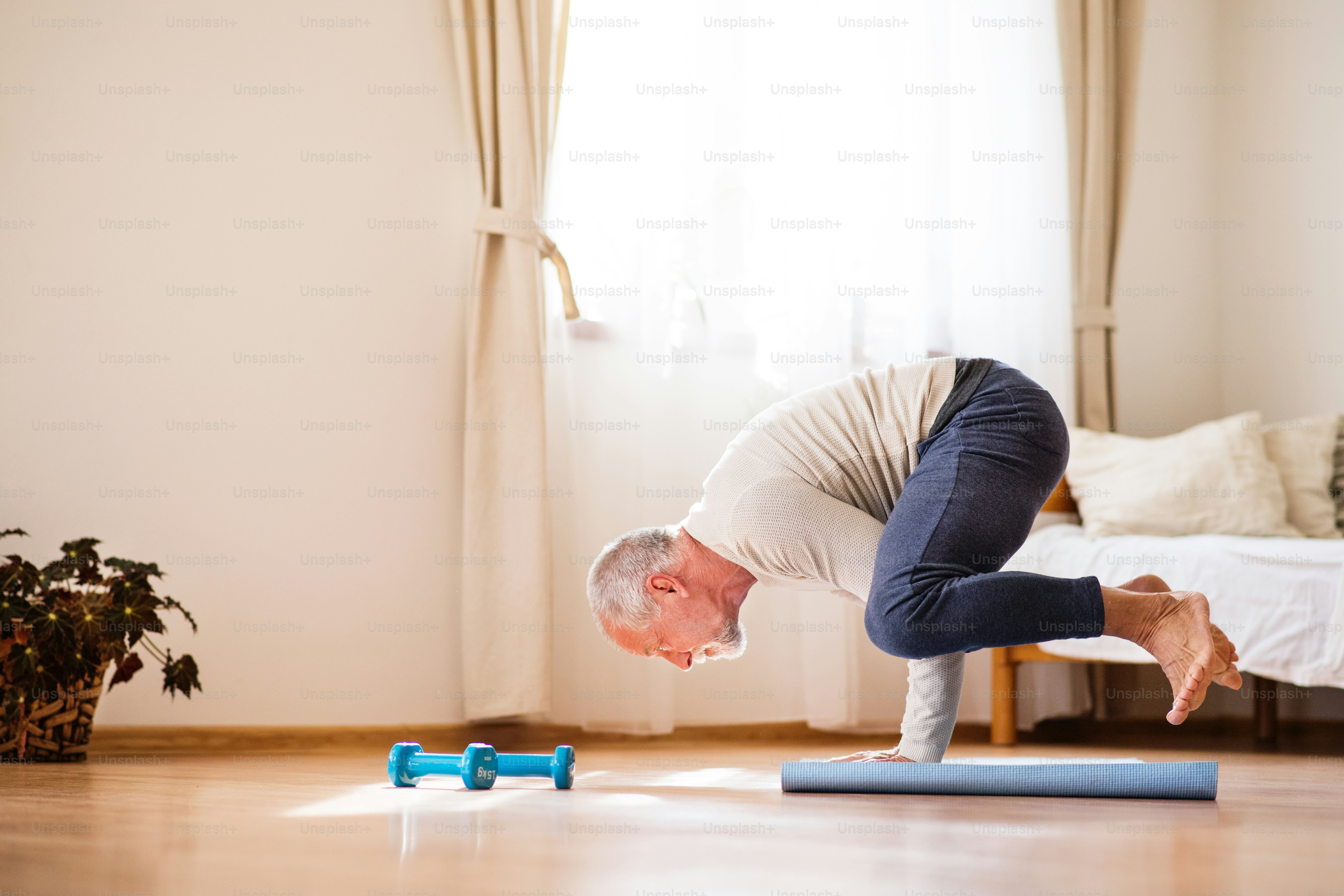 Active senior man doing exercise at home. Man next to a wheelchair ...