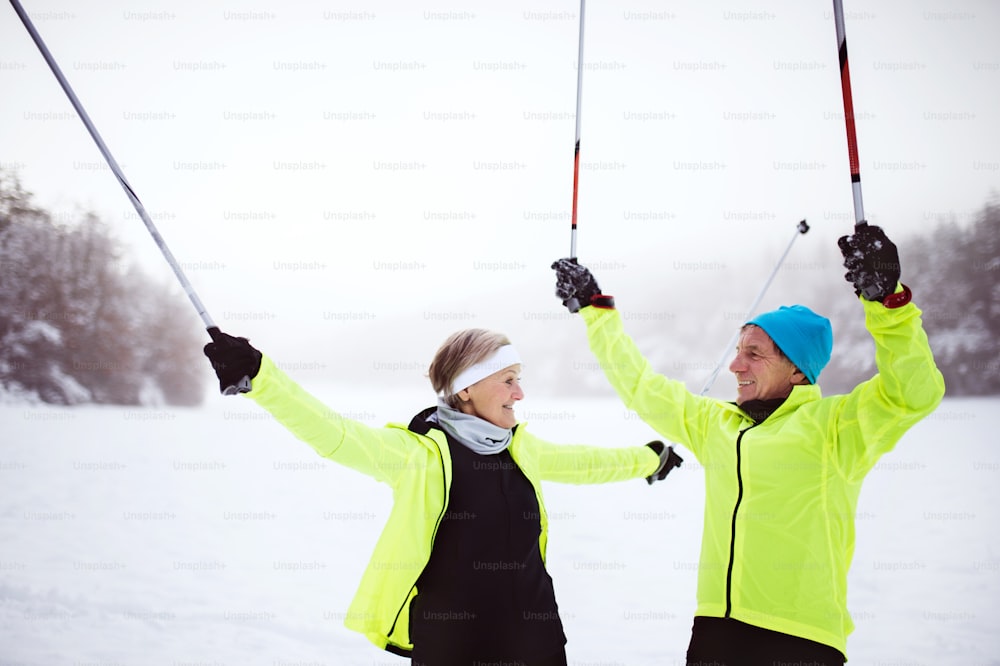 Active senior couple cross-country skiing. Winter time.