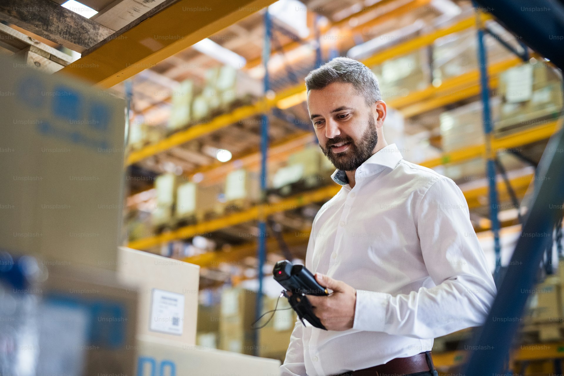 Warehouse worker scanning inventory with a handheld barcode scanner
